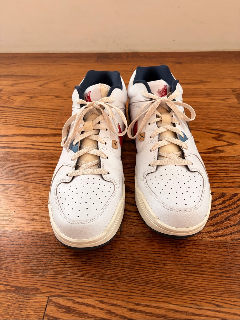 Nike White Air Jordans with Navy and Red Accents